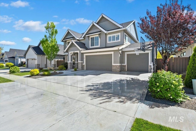 5988 N Lichfield Ave, Meridian, ID 83646 - craftsman-style house featuring fence, a residential view, stone siding, a garage, and concrete driveway