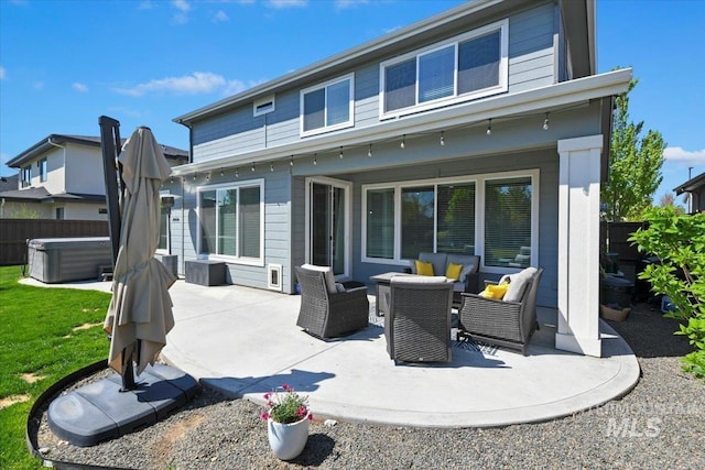 5988 N Lichfield Ave, Meridian, ID 83646 - back of property featuring a patio, a hot tub, and fence
