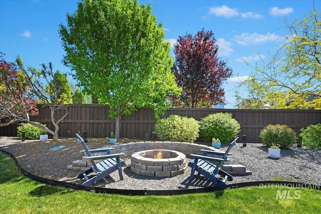 5988 N Lichfield Ave, Meridian, ID 83646 - view of patio / terrace with a fenced backyard and an outdoor fire pit