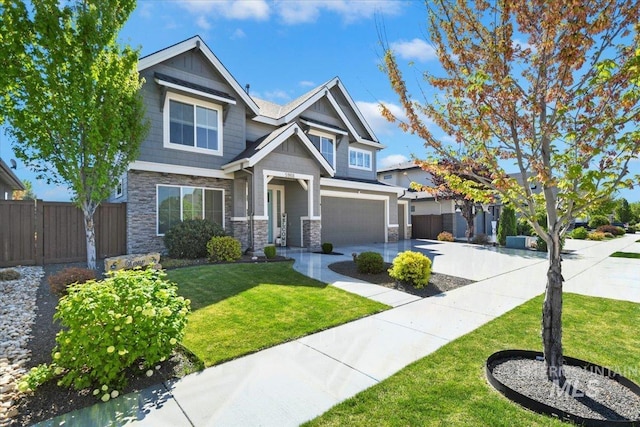 5988 N Lichfield Ave, Meridian, ID 83646 - craftsman house with an attached garage, fence, stone siding, and concrete driveway