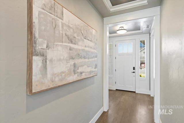 5988 N Lichfield Ave, Meridian, ID 83646 - entrance foyer featuring crown molding, a raised ceiling, baseboards, wood finished floors, and visible vents