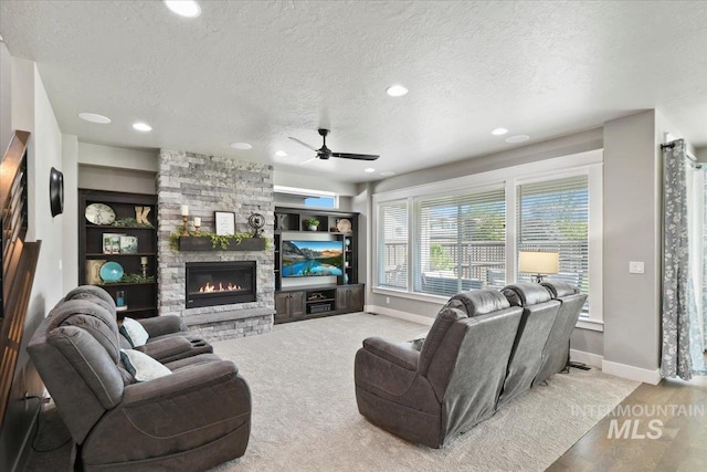 5988 N Lichfield Ave, Meridian, ID 83646 - living room with baseboards, a ceiling fan, a textured ceiling, and a fireplace