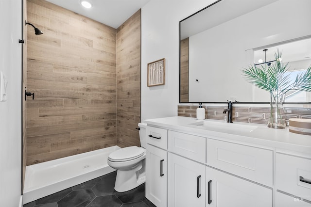 449 S Quincannon Ln, Star, ID 83669 - bathroom with tile patterned floors, toilet, a tile shower, vanity, and backsplash