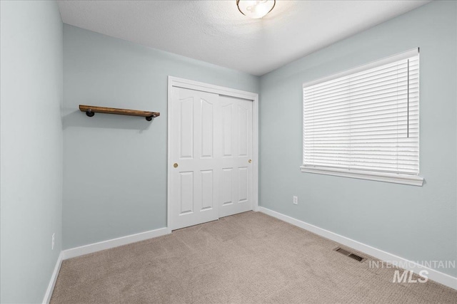 1400 W Florida Ave, Nampa, ID 83686 - unfurnished bedroom featuring carpet flooring, baseboards, and a closet