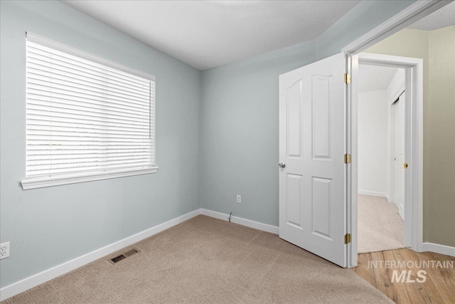 1400 W Florida Ave, Nampa, ID 83686 - unfurnished bedroom featuring baseboards and light carpet