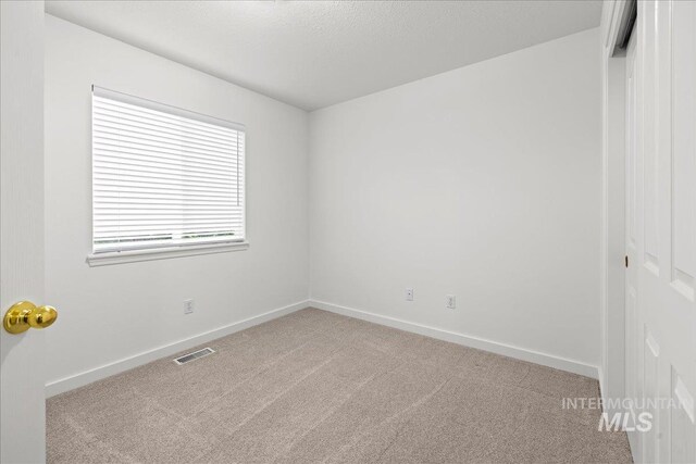 1400 W Florida Ave, Nampa, ID 83686 - carpeted empty room with baseboards