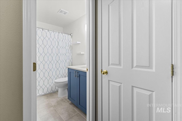 1400 W Florida Ave, Nampa, ID 83686 - full bath with vanity, toilet, tile patterned floors, and curtained shower