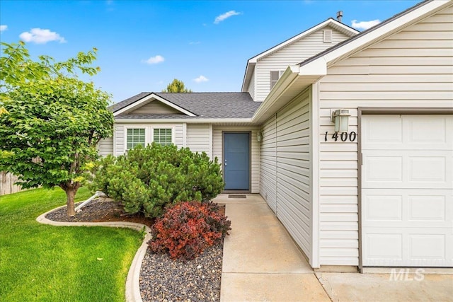 1400 W Florida Ave, Nampa, ID 83686 - entrance to property with a garage, a shingled roof, and a yard