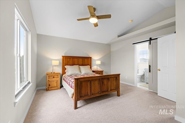 1400 W Florida Ave, Nampa, ID 83686 - bedroom featuring vaulted ceiling, light colored carpet, ensuite bathroom, baseboards, and a barn door