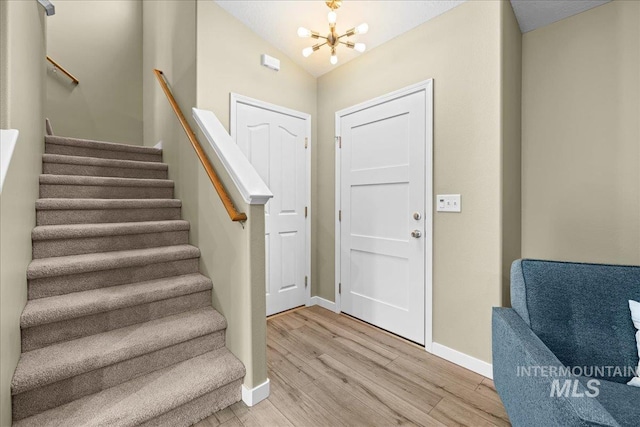 1400 W Florida Ave, Nampa, ID 83686 - foyer featuring a chandelier, baseboards, light wood-style flooring, stairway, and lofted ceiling