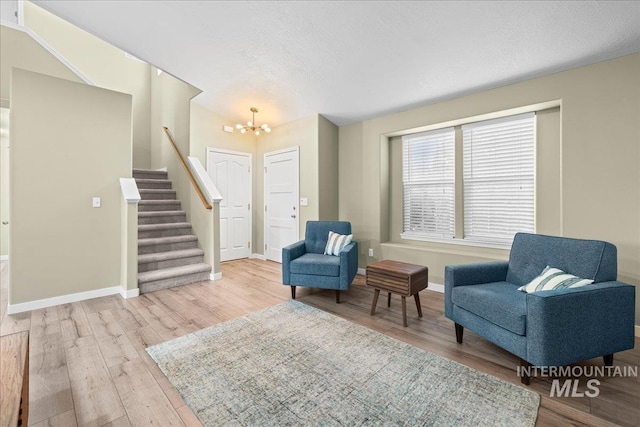 1400 W Florida Ave, Nampa, ID 83686 - sitting room with stairway, wood finished floors, a chandelier, baseboards, and a textured ceiling