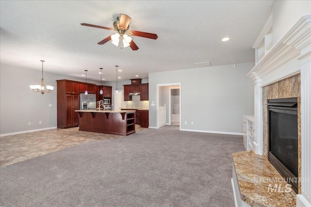 633 S Archstone Way, Boise, ID 83709 - unfurnished living room with a fireplace, a ceiling fan, a chandelier, recessed lighting, and light colored carpet