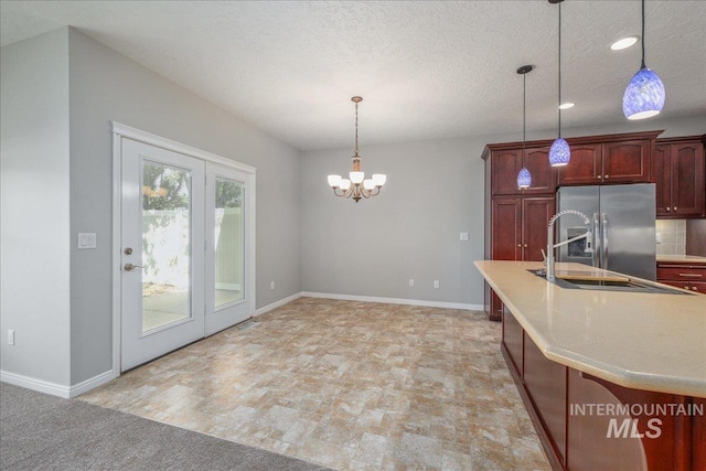 633 S Archstone Way, Boise, ID 83709 - kitchen with stainless steel fridge with ice dispenser, light countertops, hanging light fixtures, a chandelier, and recessed lighting