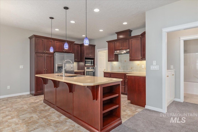 633 S Archstone Way, Boise, ID 83709 - kitchen with stainless steel appliances, light countertops, under cabinet range hood, tasteful backsplash, and a breakfast bar