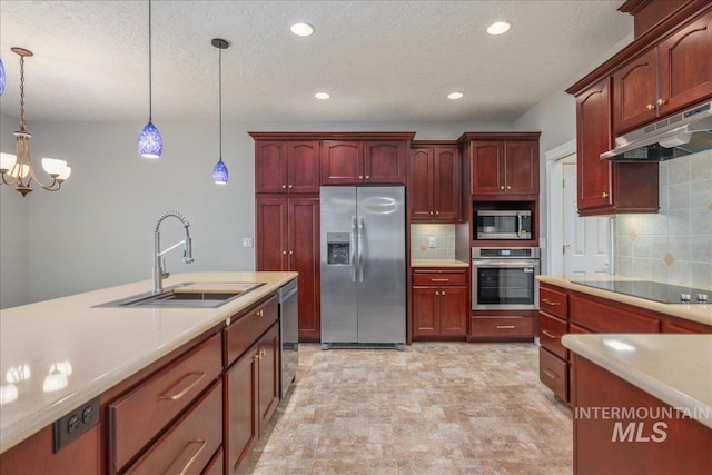 633 S Archstone Way, Boise, ID 83709 - kitchen featuring appliances with stainless steel finishes, reddish brown cabinets, hanging light fixtures, light countertops, and recessed lighting