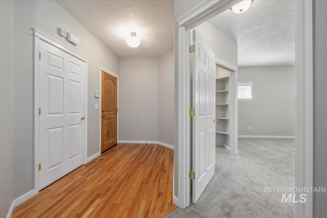 633 S Archstone Way, Boise, ID 83709 - hall featuring a textured ceiling and light wood-style floors