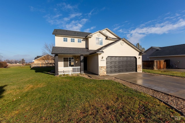 view of front of property featuring a front lawn, a porch, and a garage