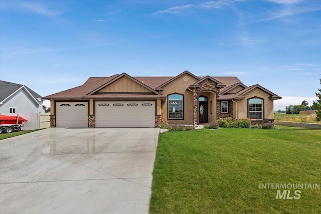 view of front of home with a front yard and a garage