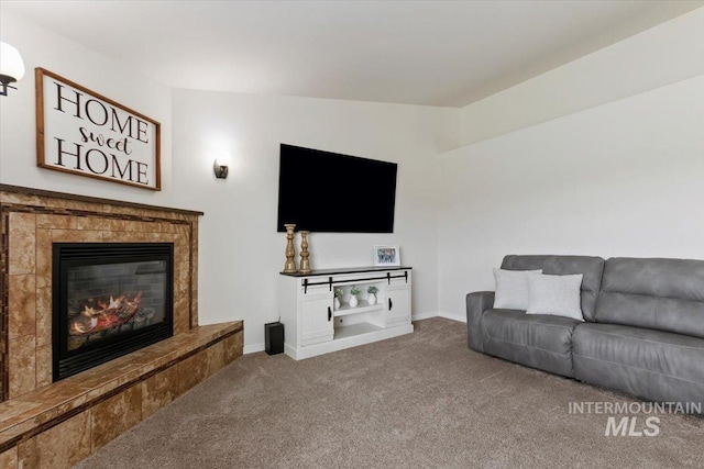 living room with a fireplace, carpet, and vaulted ceiling