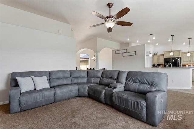 carpeted living room with ceiling fan