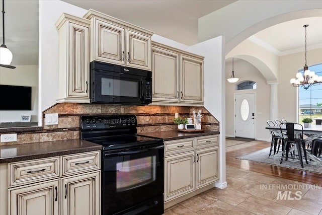 kitchen featuring cream cabinetry, tasteful backsplash, and black appliances