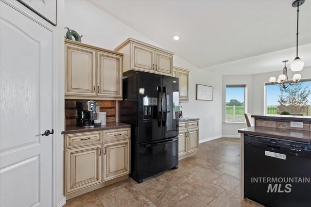 kitchen featuring hanging light fixtures, cream cabinets, a chandelier, vaulted ceiling, and black appliances