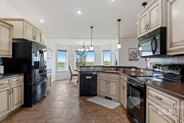 kitchen featuring sink, a notable chandelier, cream cabinets, pendant lighting, and black appliances