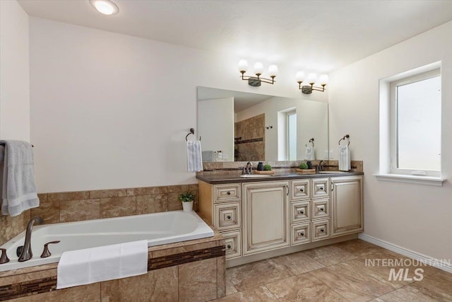 bathroom with a relaxing tiled tub and vanity