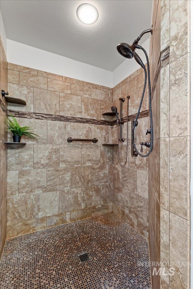 bathroom with a tile shower