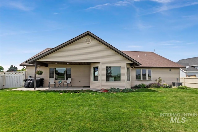 rear view of house featuring a patio and a lawn