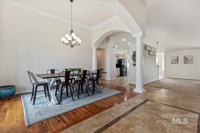 dining room with crown molding and a chandelier