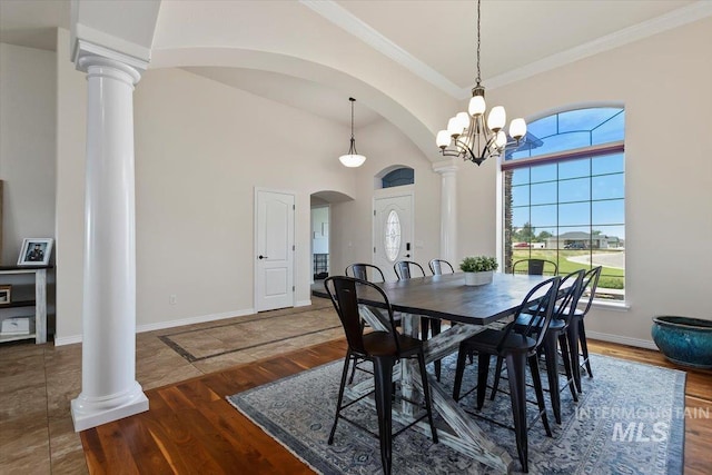 dining space featuring crown molding, dark hardwood / wood-style floors, and an inviting chandelier