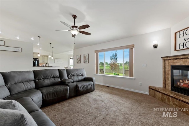 living room featuring ceiling fan, carpet, and lofted ceiling