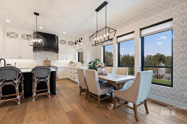 965 S Ranch House Way, Eagle, ID 83616 - dining space featuring a chandelier, light wood finished floors, wallpapered walls, and recessed lighting