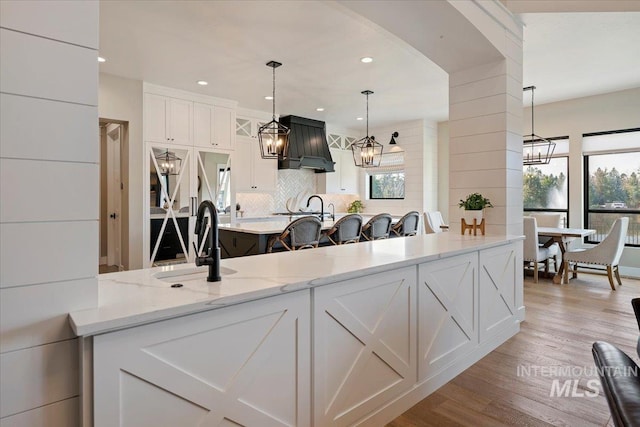 965 S Ranch House Way, Eagle, ID 83616 - kitchen with a sink, plenty of natural light, white cabinetry, light wood-type flooring, and recessed lighting