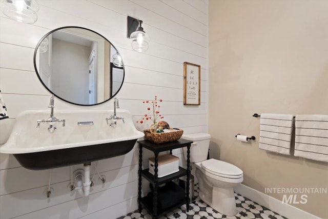 965 S Ranch House Way, Eagle, ID 83616 - bathroom with toilet, wood walls, baseboards, and tile patterned flooring