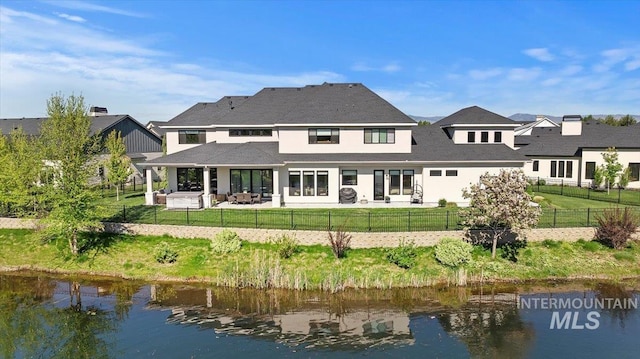 965 S Ranch House Way, Eagle, ID 83616 - back of property with a water view, a patio, and stucco siding