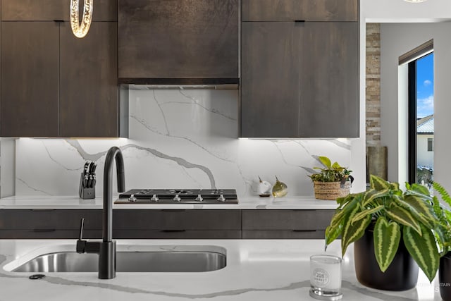 kitchen featuring tasteful backsplash, modern cabinets, and a sink