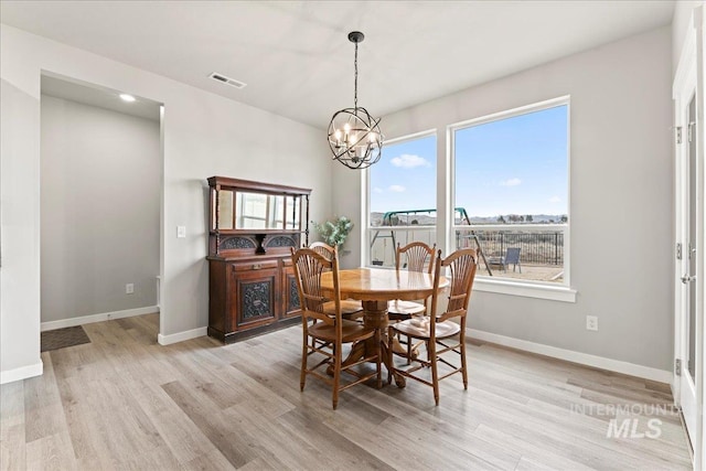 dining space featuring a notable chandelier, visible vents, light wood-style flooring, and baseboards