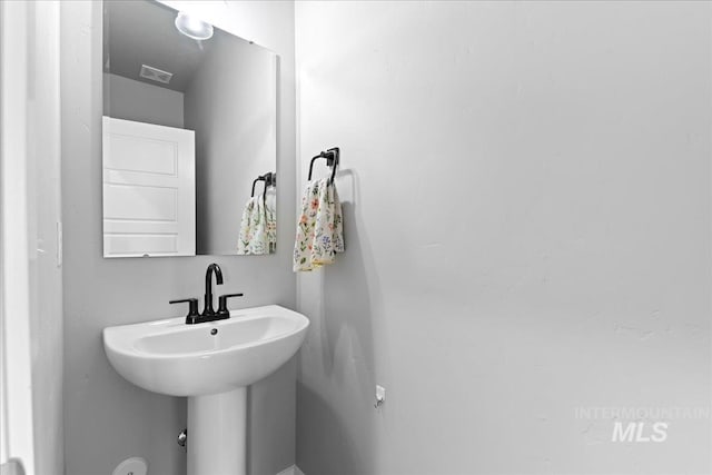 bathroom featuring visible vents and a sink