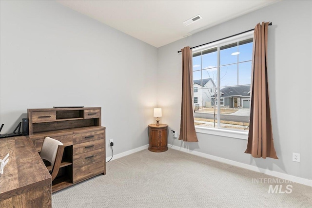 office featuring carpet, visible vents, and baseboards