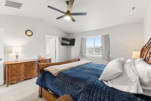 bedroom featuring a ceiling fan, vaulted ceiling, light colored carpet, and visible vents