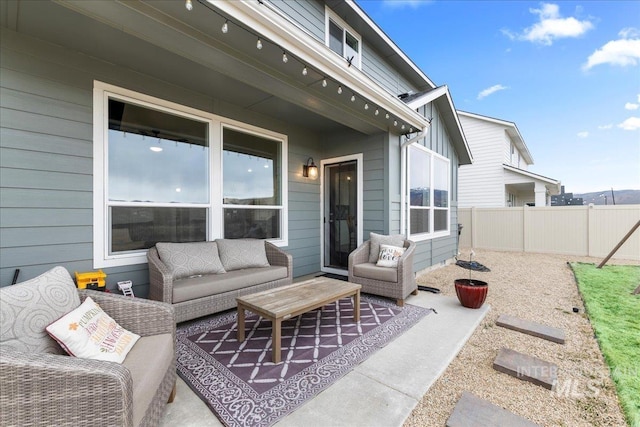 view of patio featuring outdoor lounge area and fence