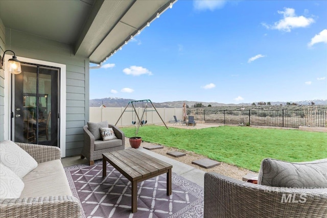 view of patio / terrace featuring an outdoor living space, a fenced backyard, and a mountain view