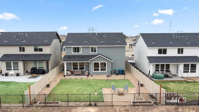 back of house featuring a yard, a fenced backyard, and a patio area