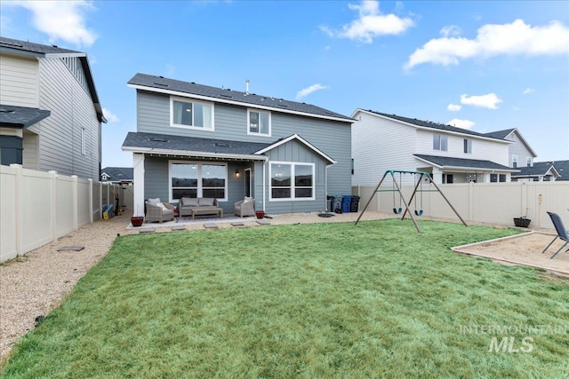 rear view of house with a patio, a lawn, a fenced backyard, and an outdoor hangout area