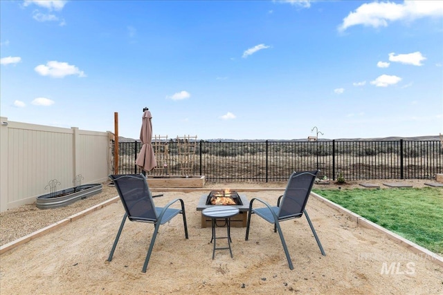 view of yard with a fenced backyard and an outdoor fire pit