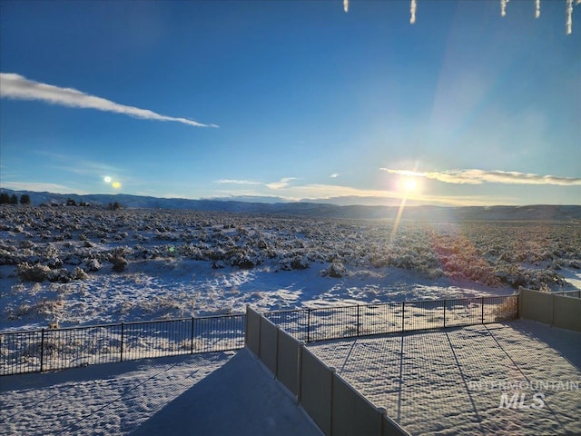 view of patio / terrace with a mountain view and fence