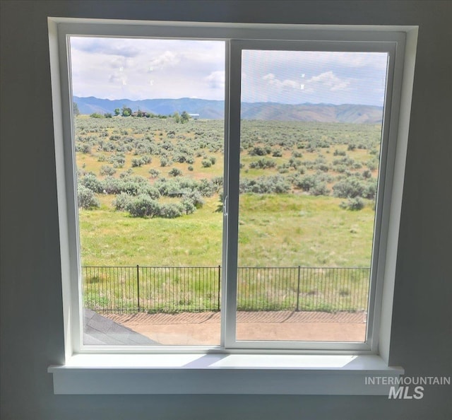 doorway to outside featuring a wealth of natural light and a mountain view