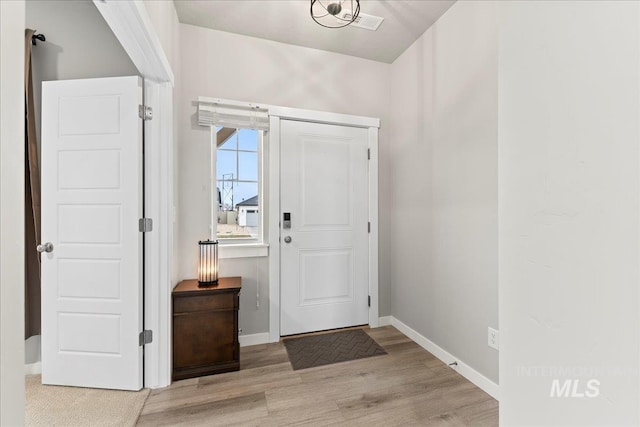 entryway with baseboards and wood finished floors